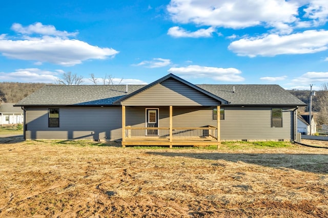 back of house with a shingled roof, crawl space, a wooden deck, and a lawn