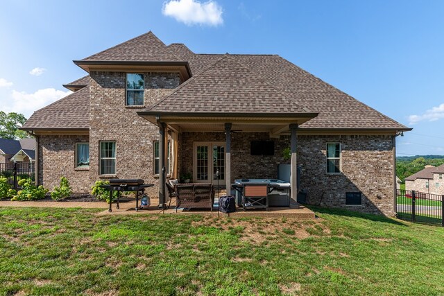 rear view of property with a patio area, a shingled roof, fence, and a lawn