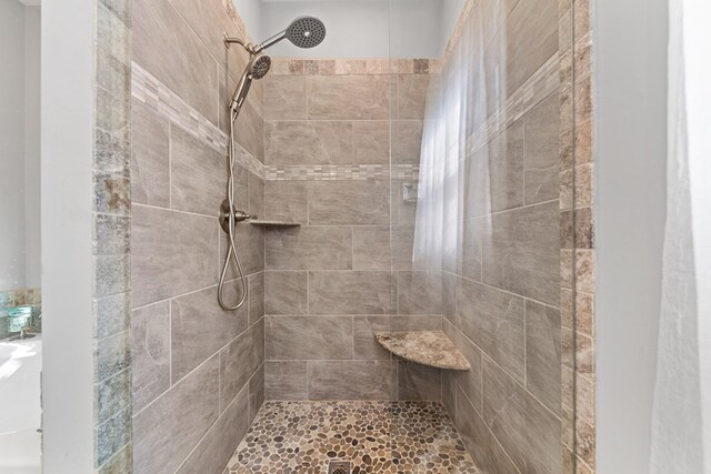 full bathroom with a tile shower