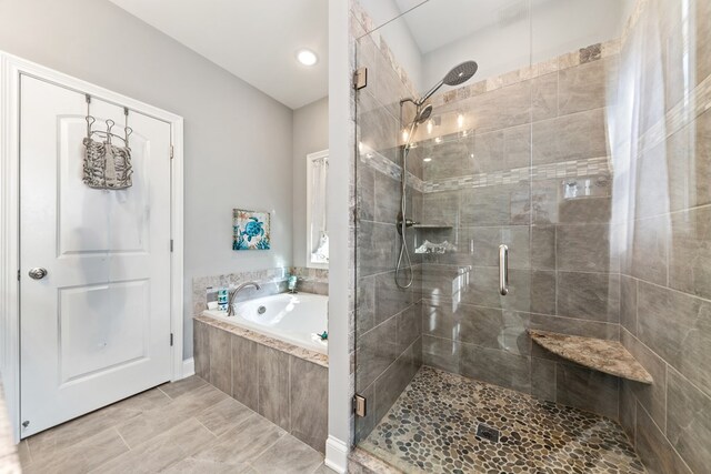 bathroom featuring a garden tub and a stall shower