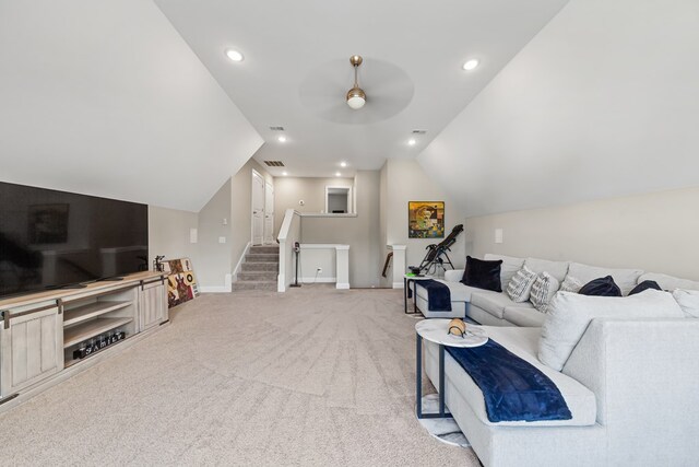 living room with lofted ceiling, recessed lighting, baseboards, and light colored carpet