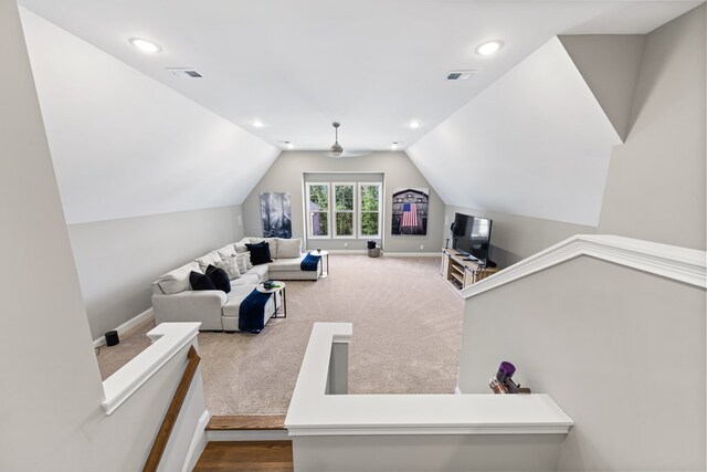 living room with recessed lighting, visible vents, carpet flooring, vaulted ceiling, and baseboards