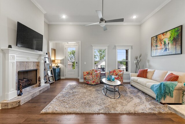 living room with dark wood-style floors, plenty of natural light, and crown molding