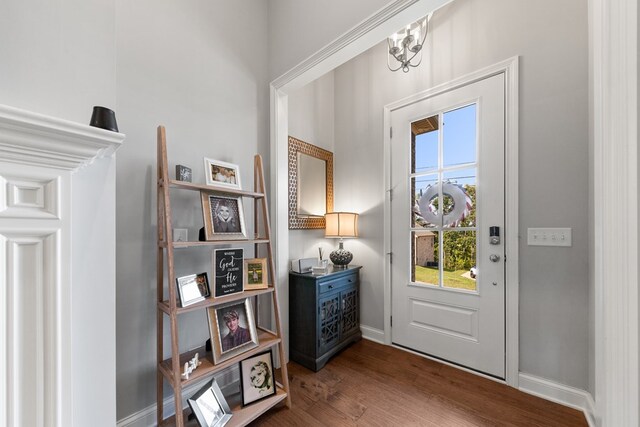 foyer entrance with wood finished floors and baseboards