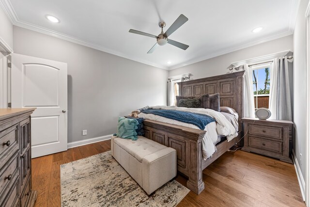 bedroom featuring ceiling fan, recessed lighting, wood finished floors, baseboards, and crown molding