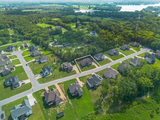 birds eye view of property with a residential view and a water view