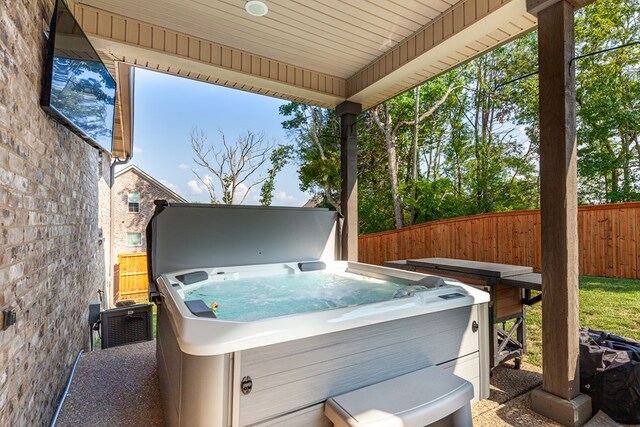 view of patio / terrace with fence private yard and a hot tub