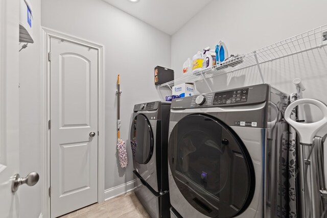 laundry area featuring laundry area, washer and clothes dryer, and baseboards