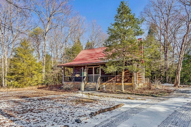 chalet / cabin with covered porch and metal roof