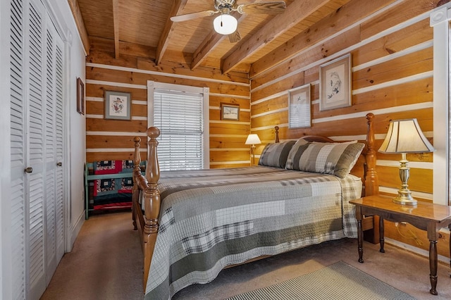 bedroom featuring carpet floors, beamed ceiling, and wooden walls