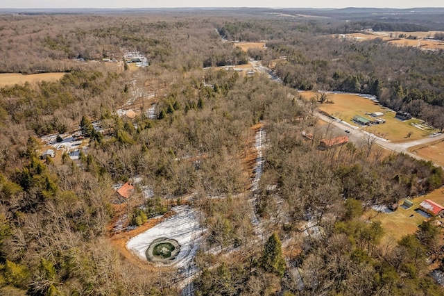 birds eye view of property with a wooded view