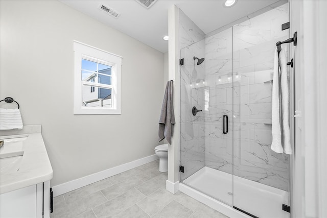 bathroom featuring vanity, visible vents, baseboards, a marble finish shower, and toilet