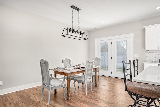 dining space with recessed lighting, wood finished floors, and baseboards