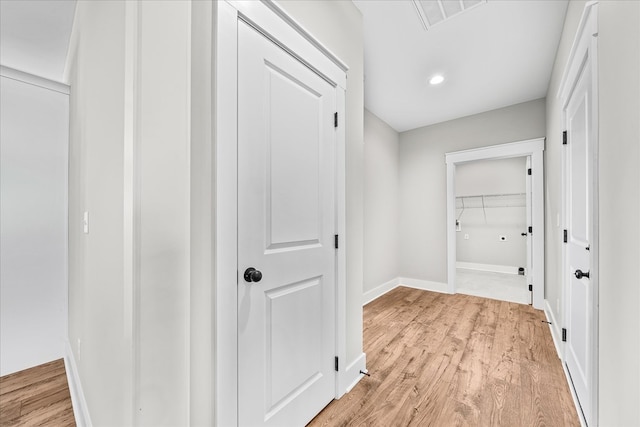 hallway featuring recessed lighting, visible vents, baseboards, and light wood finished floors