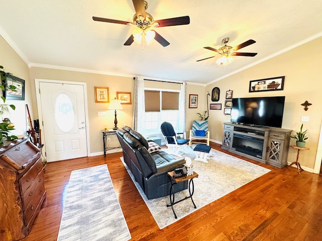 living room with ornamental molding, wood finished floors, and a wealth of natural light