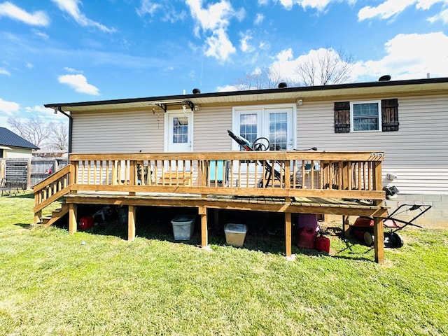 rear view of property featuring a deck and a yard