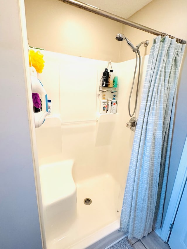 full bath with a shower stall