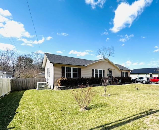 ranch-style house with fence and a front lawn