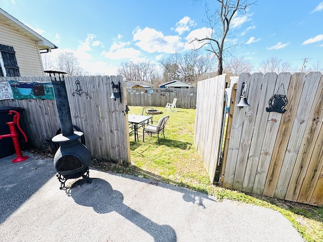 view of patio with a gate and fence