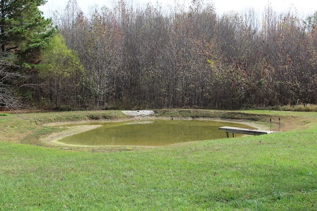 view of community with a water view and a lawn