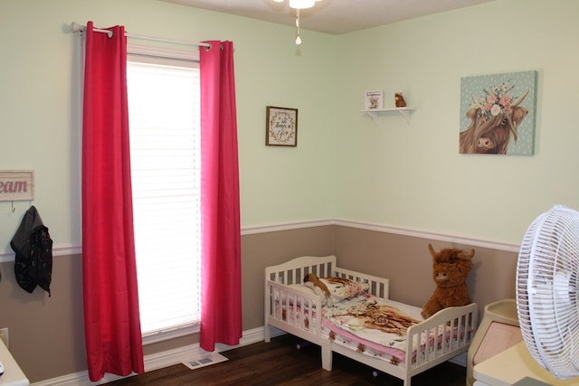 bedroom with visible vents and dark wood-style flooring