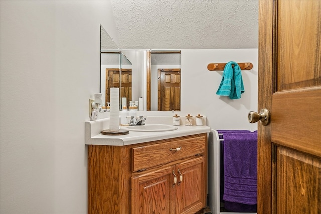 bathroom featuring a textured ceiling and vanity