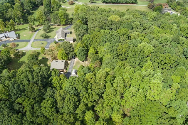 birds eye view of property featuring a wooded view