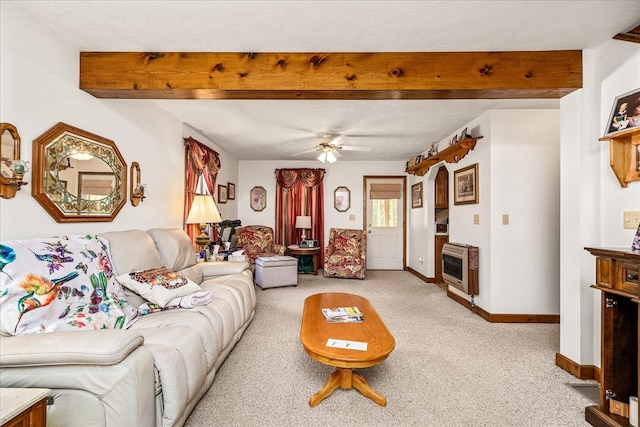 living room with heating unit, light colored carpet, a textured ceiling, beamed ceiling, and baseboards