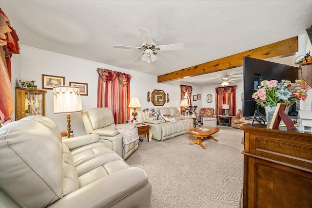 living room with carpet floors, beamed ceiling, a textured ceiling, and a ceiling fan