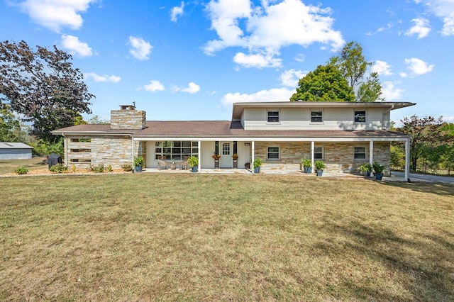 back of property featuring stone siding, a patio area, a chimney, and a lawn