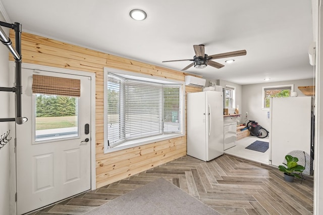 doorway to outside with recessed lighting, an AC wall unit, ceiling fan, and wooden walls