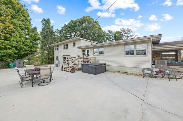 rear view of property with outdoor dining space, a patio area, and an outdoor hangout area