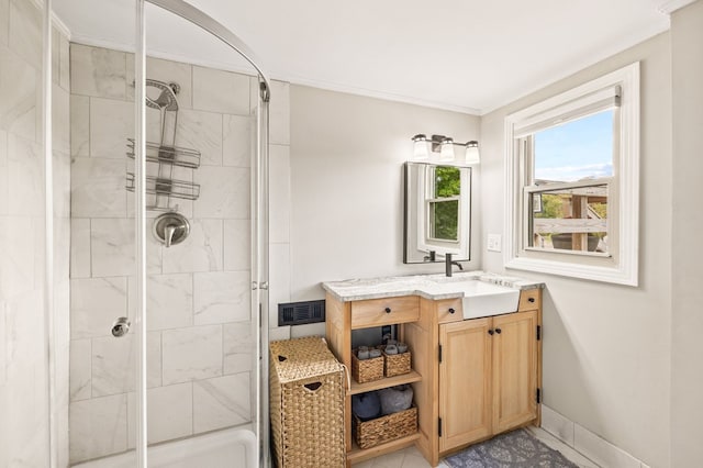 full bathroom featuring crown molding, visible vents, a stall shower, vanity, and baseboards