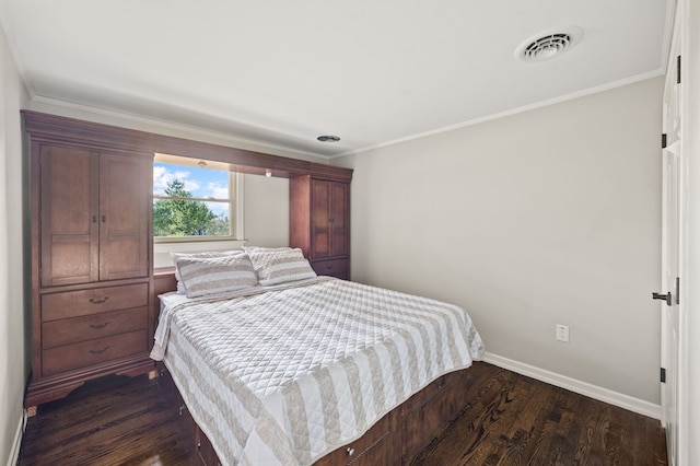 bedroom with crown molding, visible vents, dark wood finished floors, and baseboards