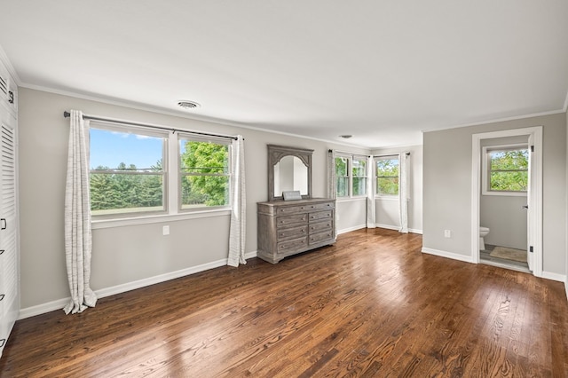 interior space featuring dark wood-style floors, ornamental molding, visible vents, and baseboards