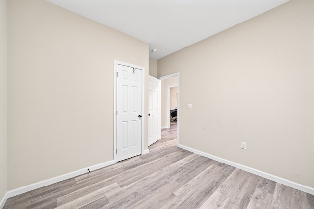 unfurnished room featuring light wood-type flooring and baseboards