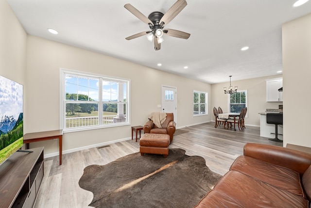 living area featuring baseboards, recessed lighting, visible vents, and light wood-style floors