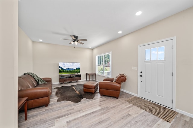 living room with baseboards, ceiling fan, light wood-style flooring, and recessed lighting