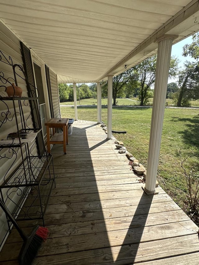 wooden terrace with a lawn