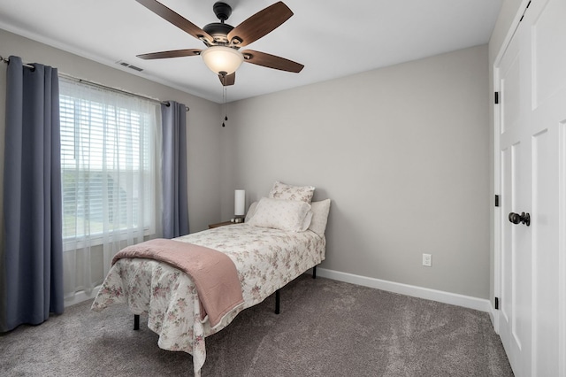 carpeted bedroom with baseboards, visible vents, and ceiling fan