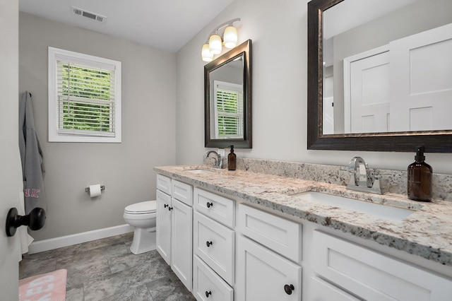 bathroom featuring a sink, visible vents, and a healthy amount of sunlight