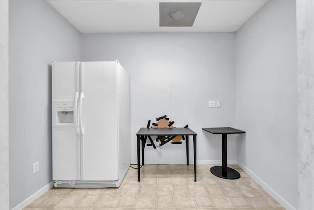 miscellaneous room featuring a drop ceiling and baseboards