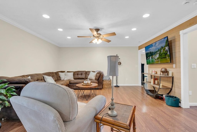 living area featuring crown molding, recessed lighting, ceiling fan, light wood-type flooring, and baseboards