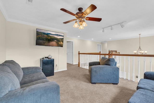 carpeted living area featuring rail lighting, baseboards, visible vents, and ornamental molding