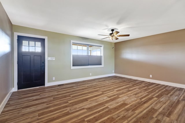 entrance foyer with dark wood-style floors, ceiling fan, and baseboards