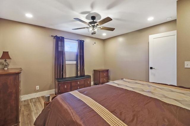 bedroom with light wood-type flooring, ceiling fan, baseboards, and recessed lighting