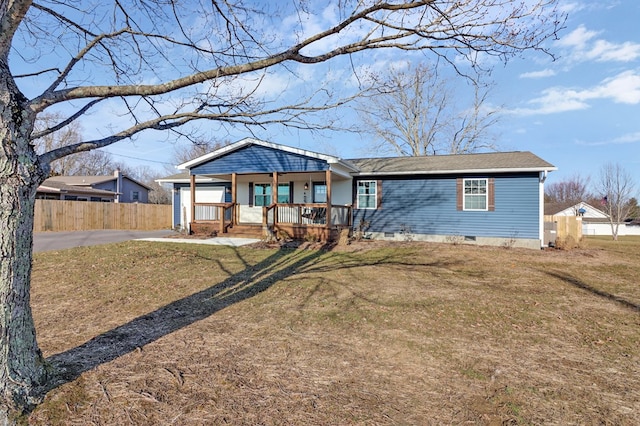 view of front of home with covered porch, crawl space, a front yard, and fence