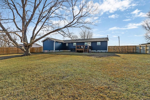 back of property with crawl space, a fenced backyard, and a lawn