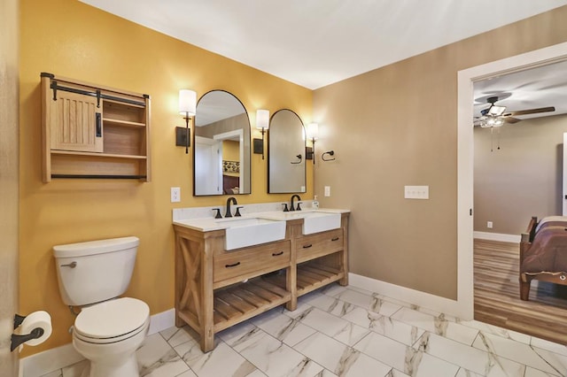 bathroom with marble finish floor, a sink, and baseboards