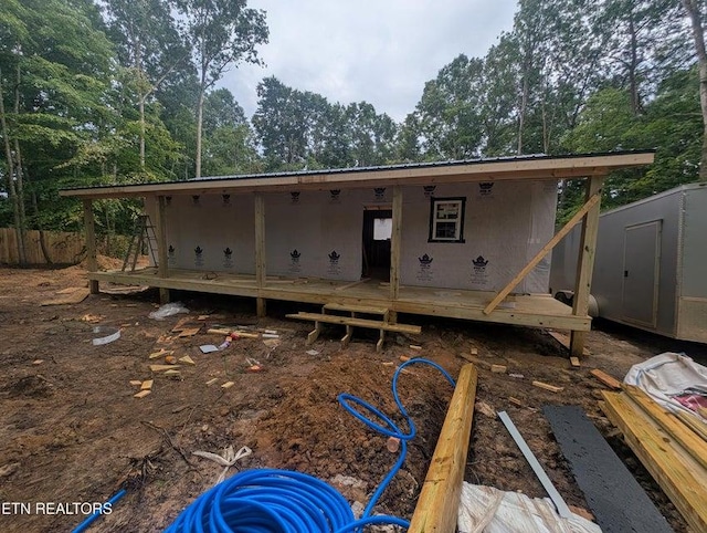470 Trimmer Ln, Jamestown, TN 38556 - back of property with a deck, a storage unit, and view of wooded area